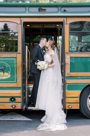 Rachael and Matthew Taylor hop on the Columbus trolley for a romantic shot, the mode of transportation for the wedding party.
